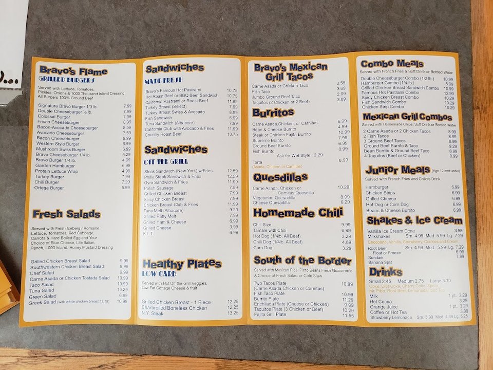 Printed menu with burritos, burgers, and breakfast items.