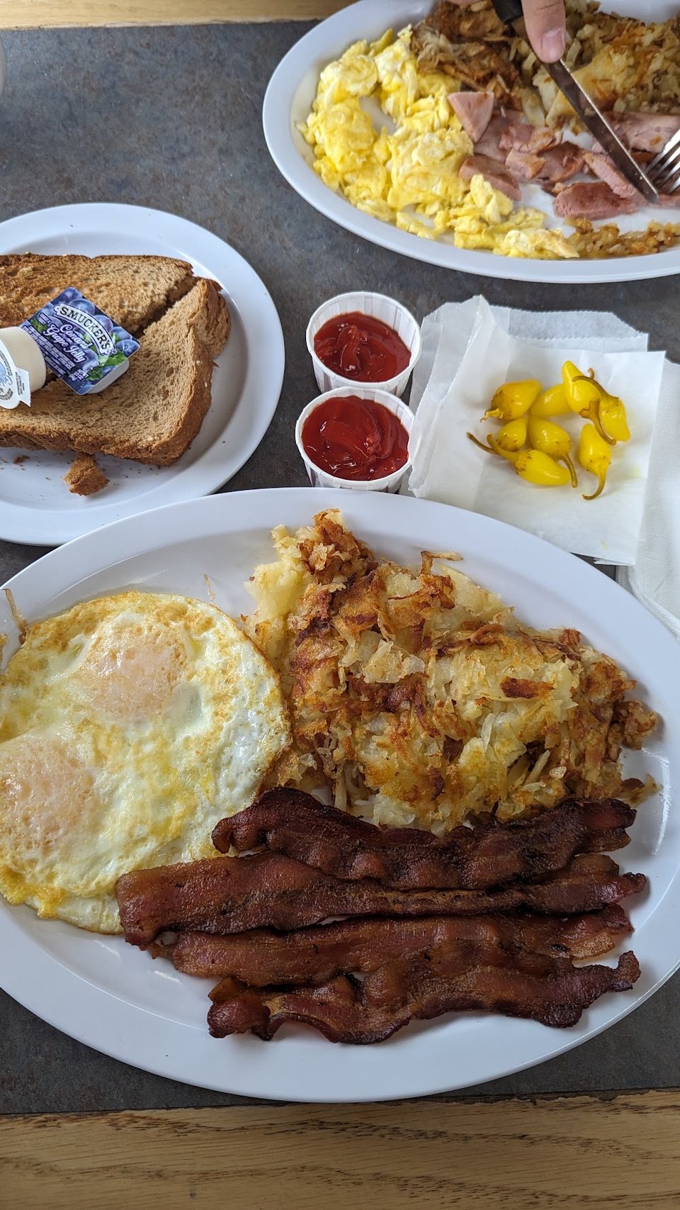 Printed menu with burritos, burgers, and breakfast items.